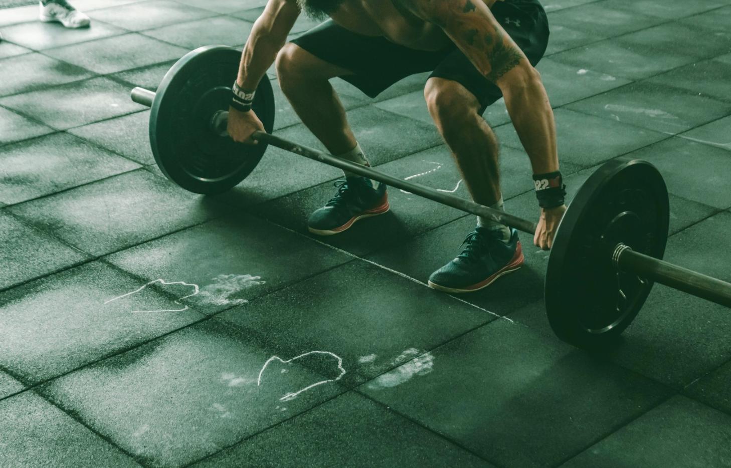 CrossFit athlete mid-session on an air bike, focused effort visible